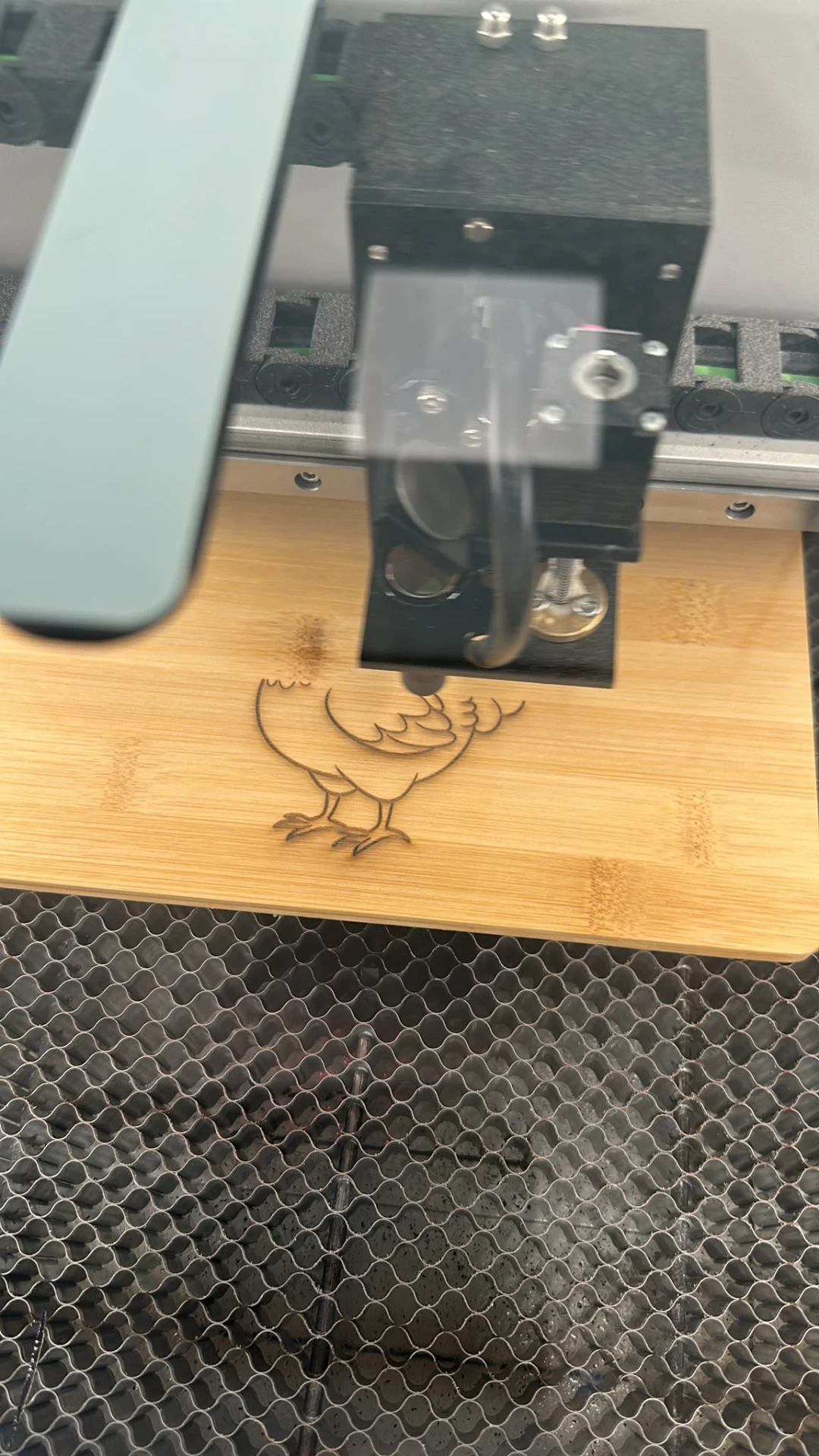 Lasergravur eines Motivs auf einem Holzbrett
